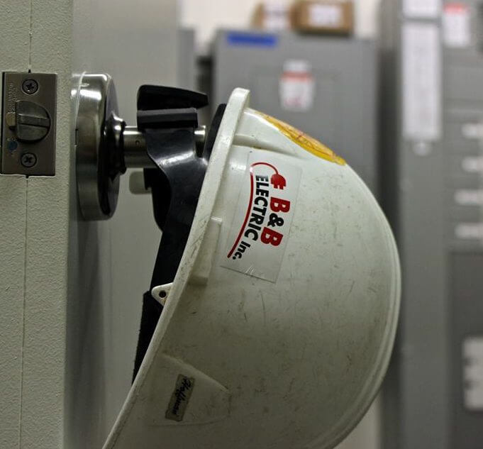Hard hat hangs on door handle